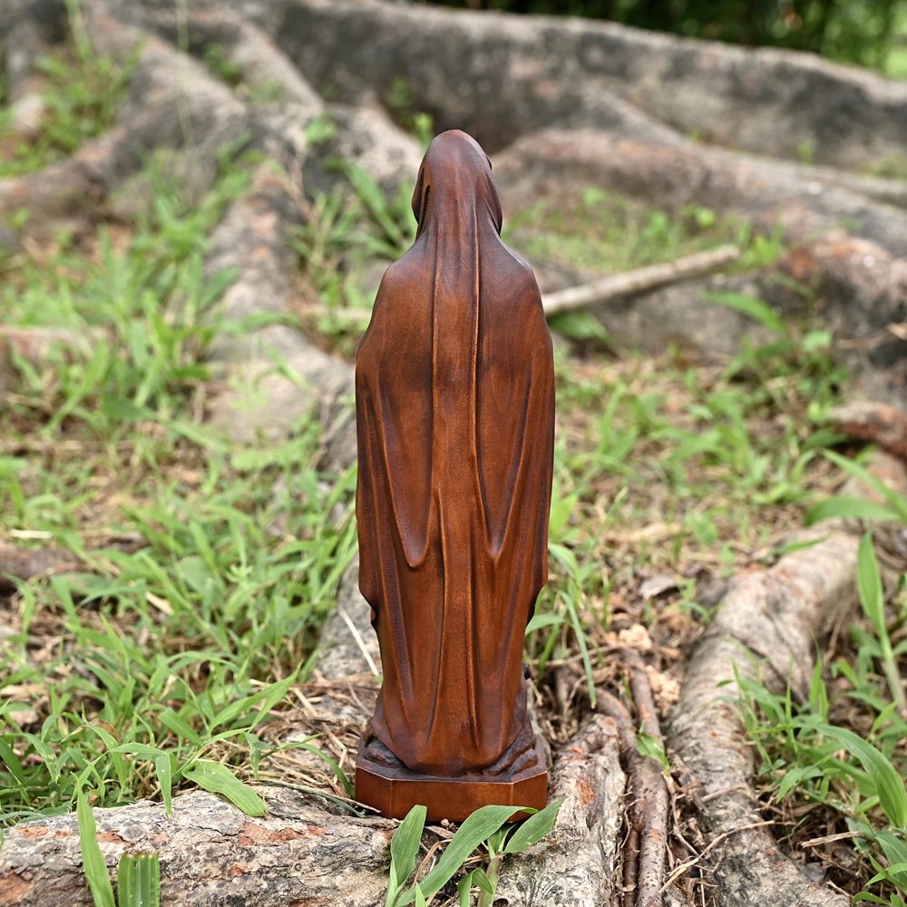 Back view of Lourdes Virgin Mary statue showing natural wood texture and detailed carving work