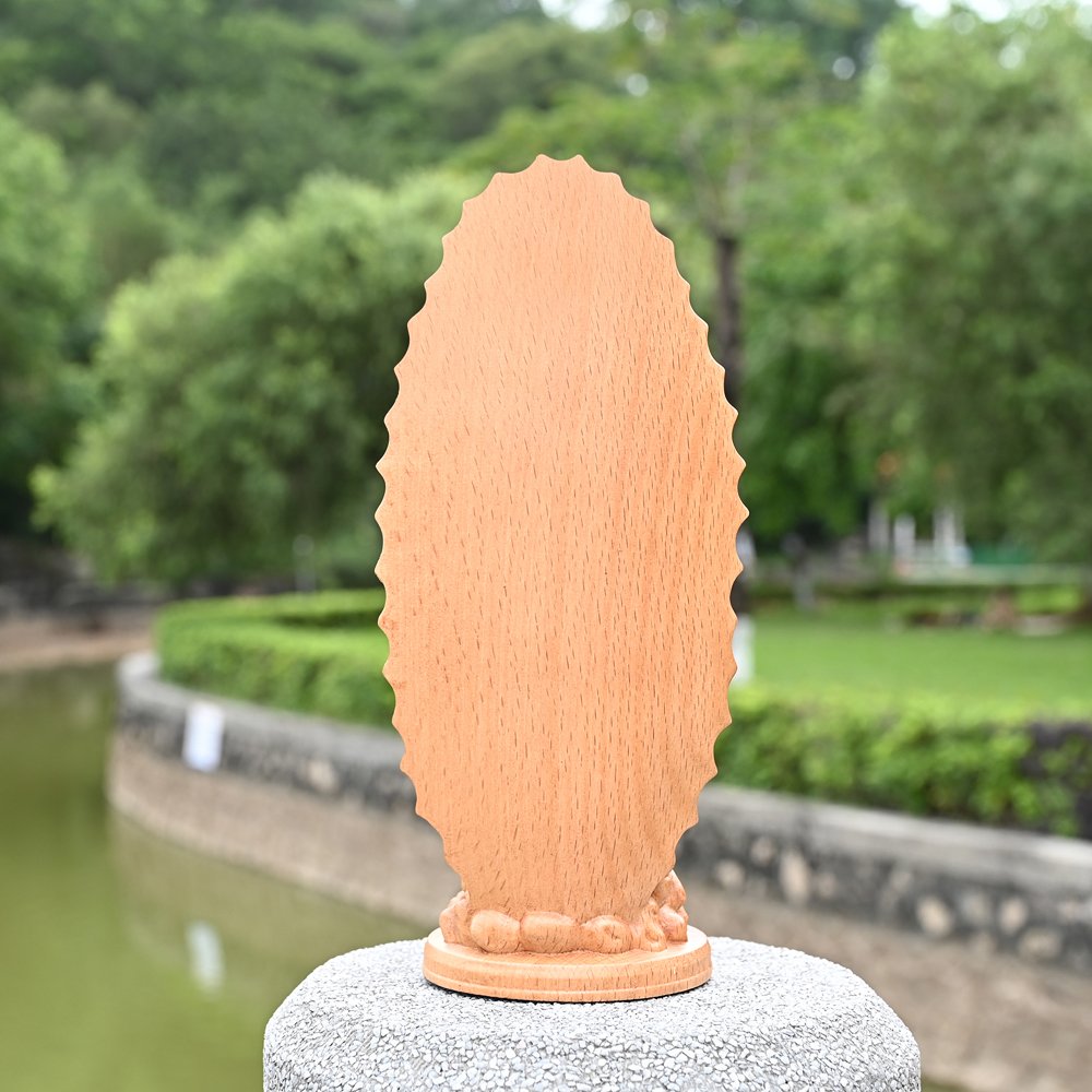 Back view of Virgin Mary wooden sculpture showing natural wood texture and handmade craftsmanship