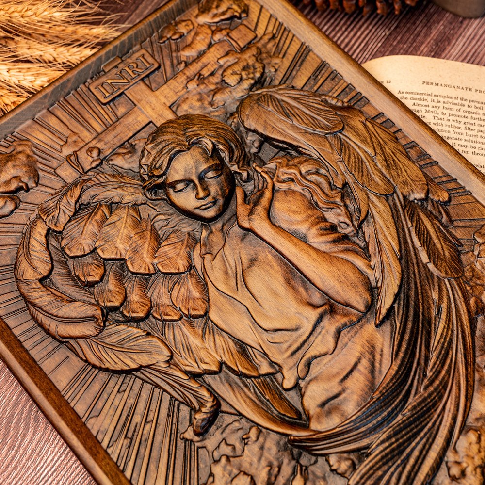 Close up of Female Angel wood relief showing detailed face, wings and handcrafted carving patterns