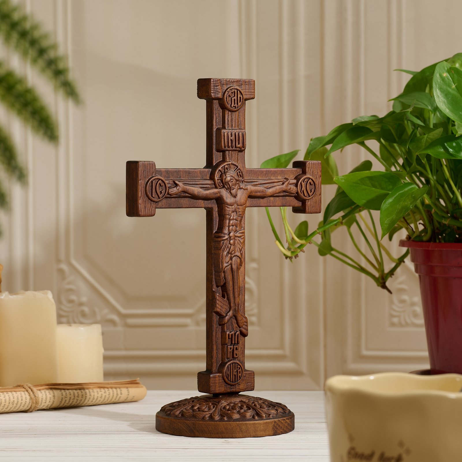 Hand carved Orthodox crucifix shown from a side angle with detailed wooden craftsmanship and carved base