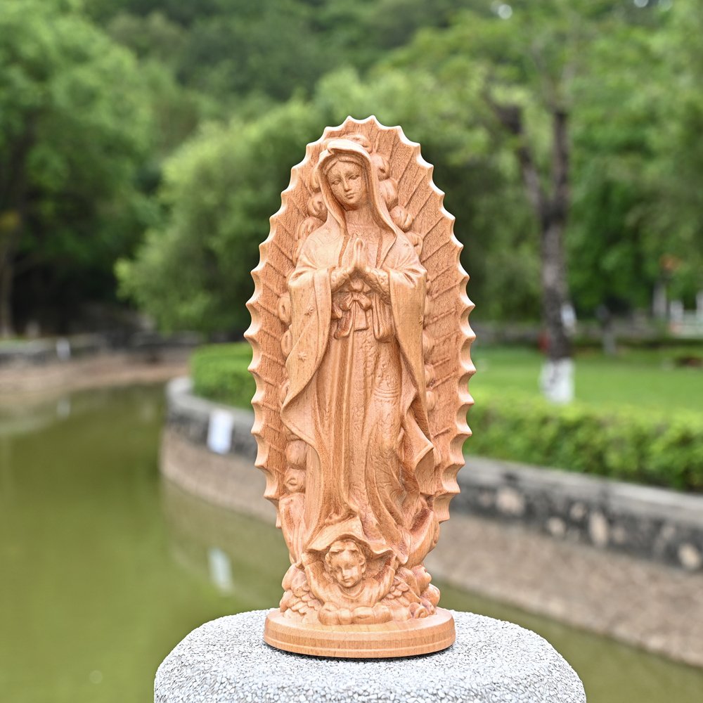 Handmade Virgin Mary wood carving statue displayed outdoors, natural wooden religious sculpture
