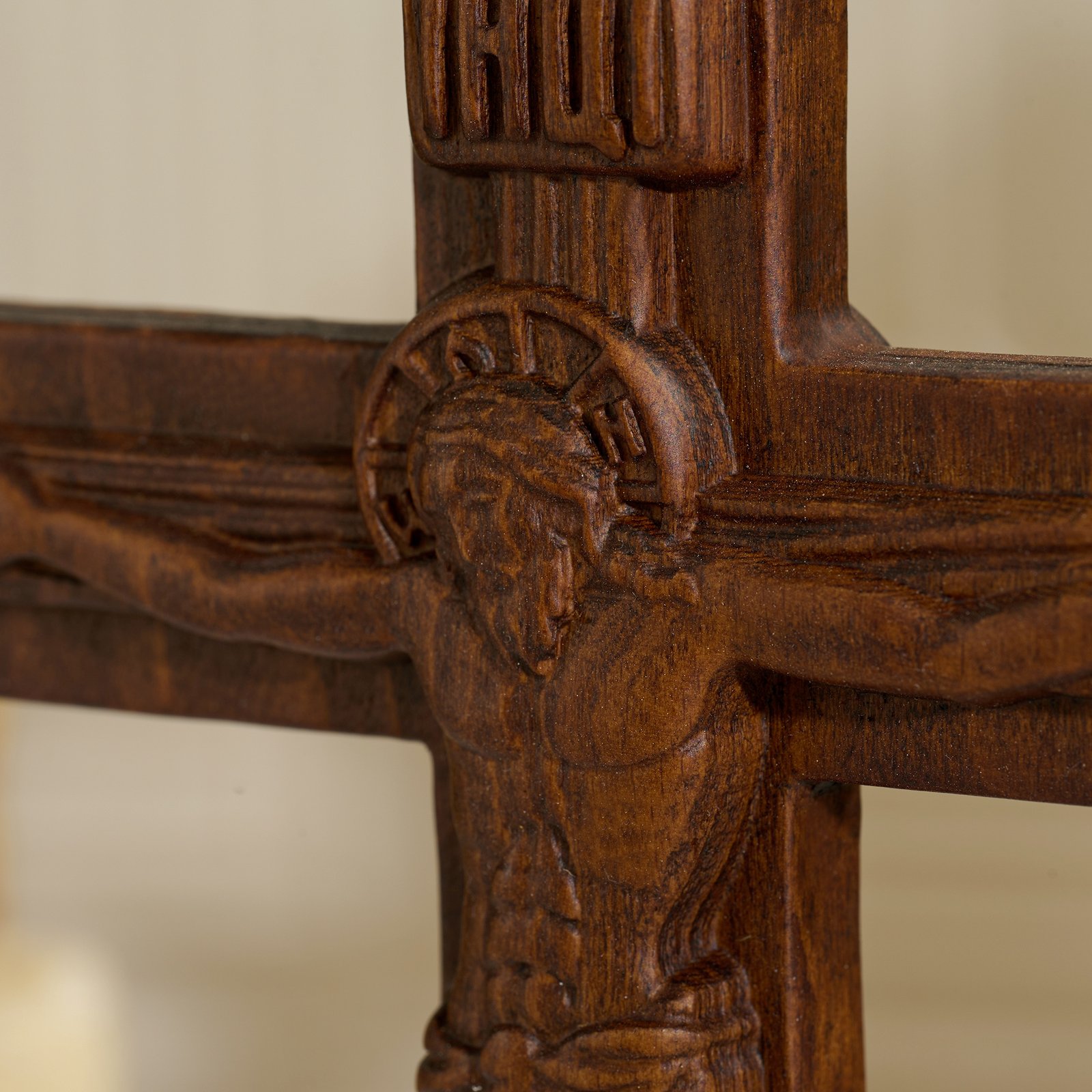 Close up detail of Jesus figure on Orthodox crucifix showing fine carving and dark wood finish
