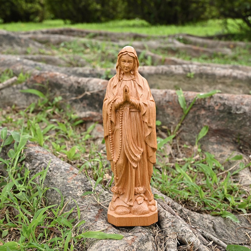 Natural wood Lourdes Virgin Mary statue with praying hands and traditional Catholic sculpture details