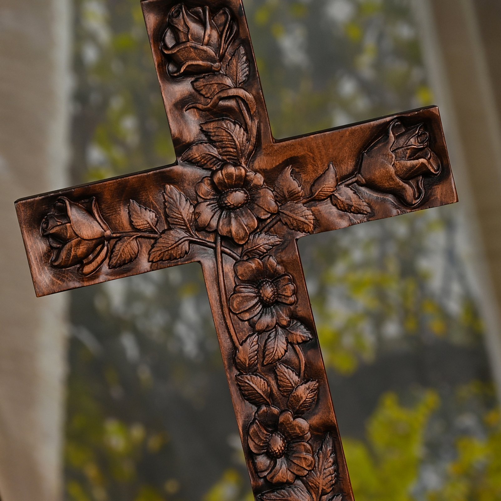 Close up of Rose Cross floral carving detail showing rose patterns and handcrafted wood texture
