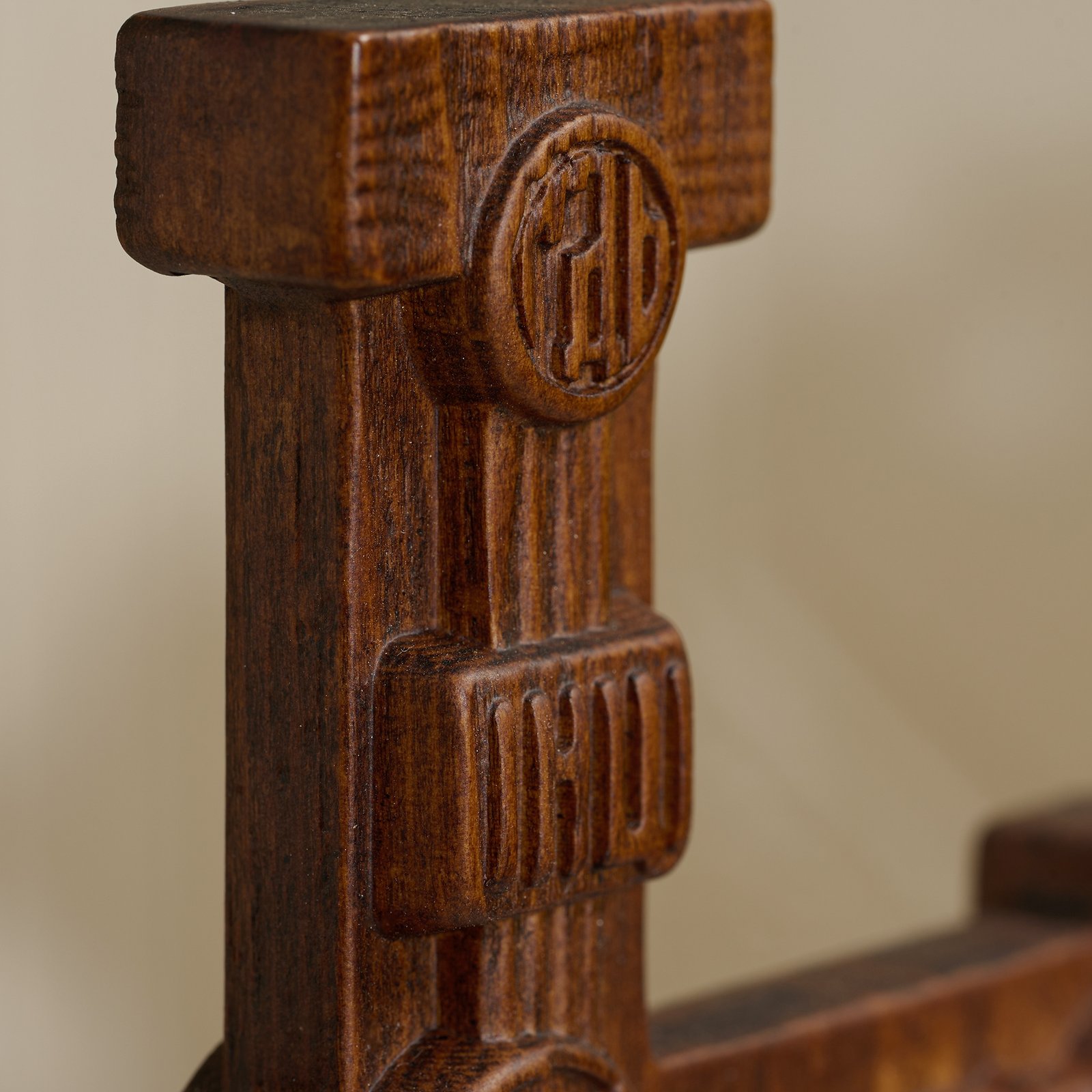 Top symbol detail of hand carved Orthodox cross showing carved Christian emblem in dark wood
