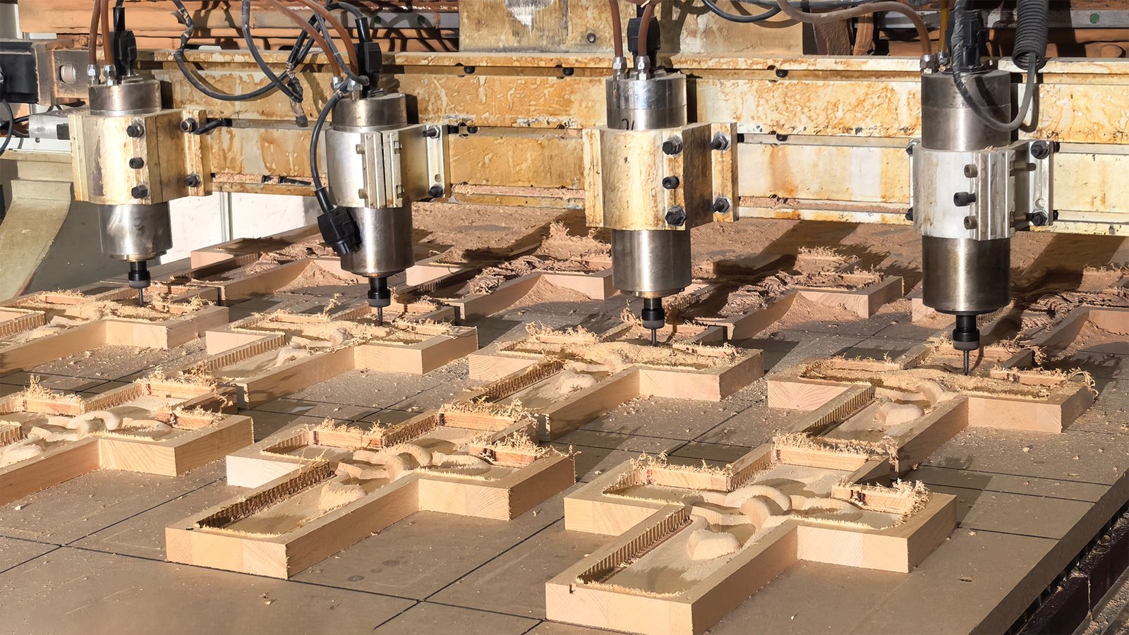 Artisan refining a Christian wood relief by cnc