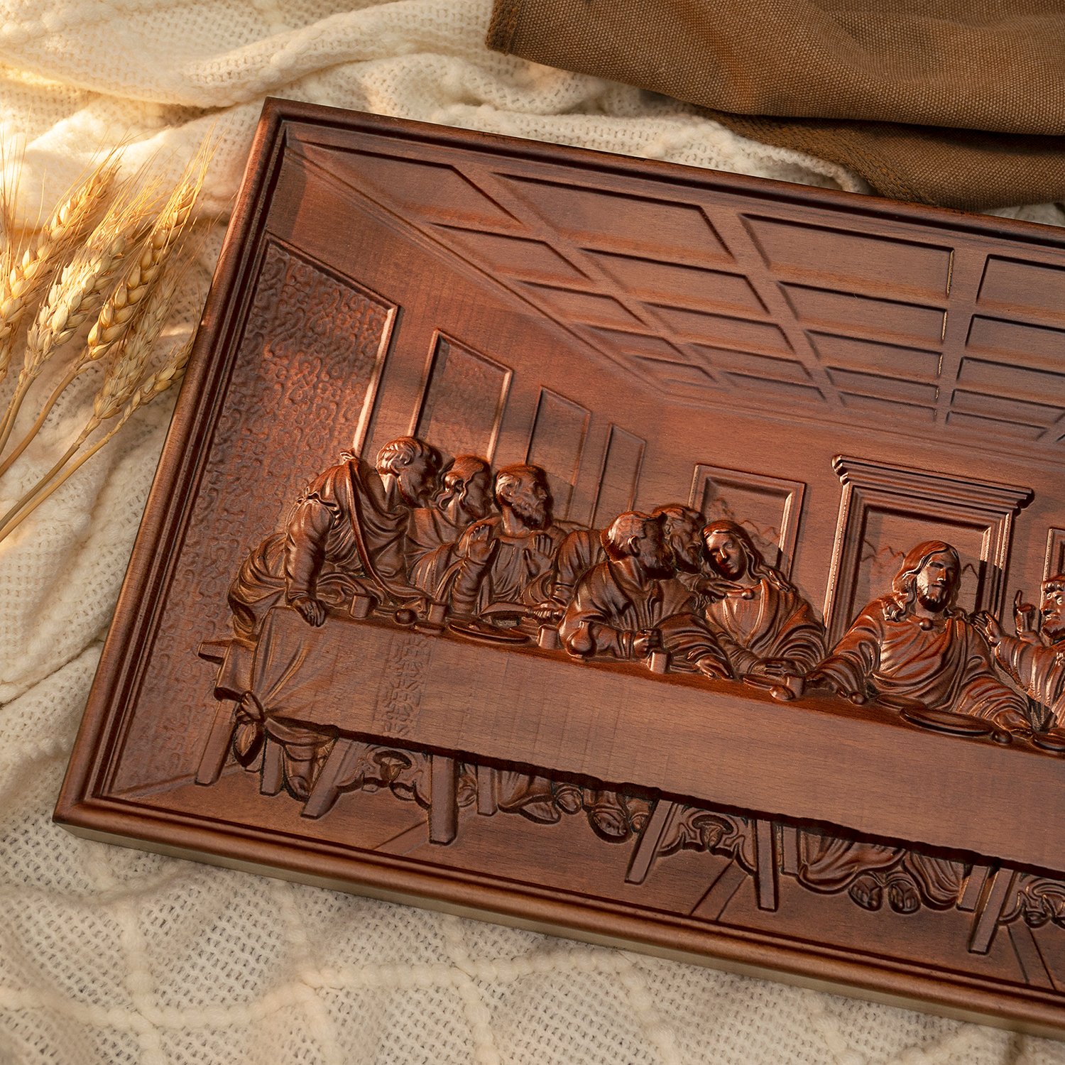 Angled close-up of a Last Supper wood carving showing Jesus and the apostles in detailed raised relief