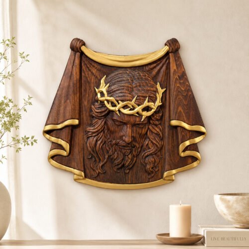 Antique gold Jesus face wood carving wall decor with gold crown of thorns and decorative trim displayed on a neutral wall