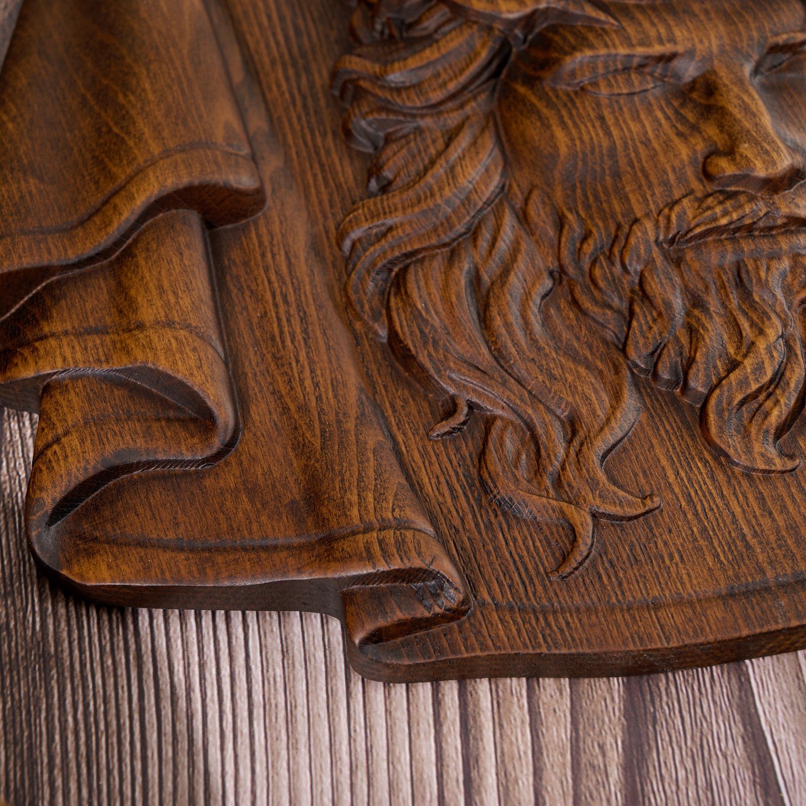 Close-up detail of the carved draped veil edge, showing wood grain texture and handcrafted relief lines