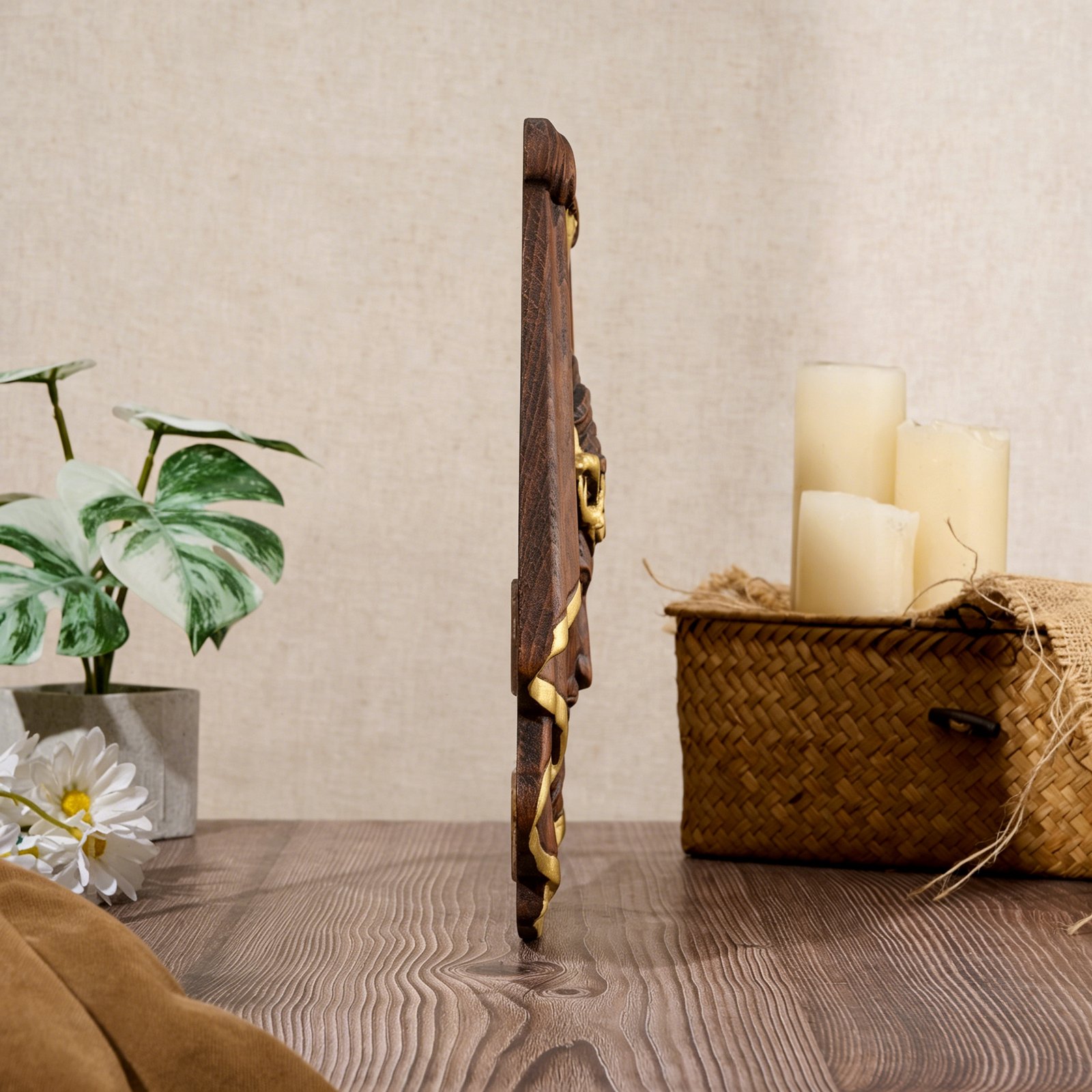 Side angle view of a handcrafted Jesus face wood carving wall art, showing the thickness and layered relief details