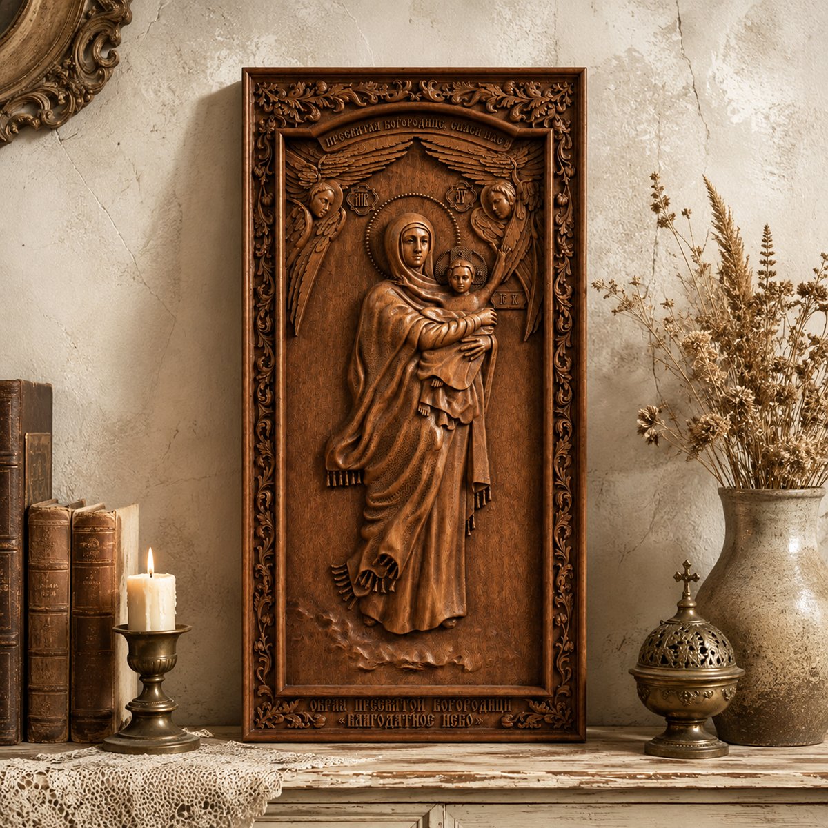 Vintage Virgin Mary and Child wooden relief displayed with candles, books and dried flowers